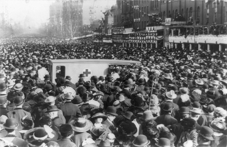 Crowd around an ambulance. Dozens of protesters were injured in the day during the march, March 3, 1913.